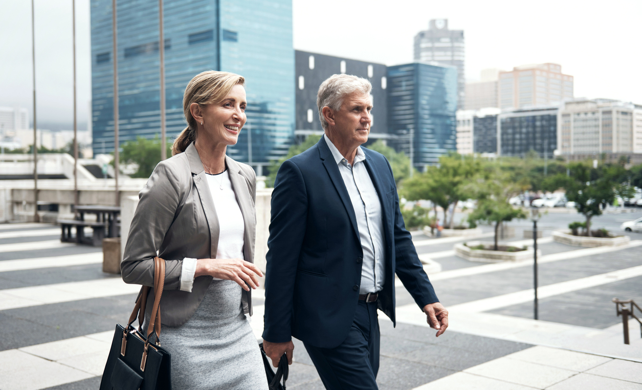 Shot of two mature businesspeople walking in the city